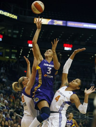 Phoenix’s Penny Taylor, left, and Candice Dupree surround Sparks’ Candace Parker. (Associated Press)