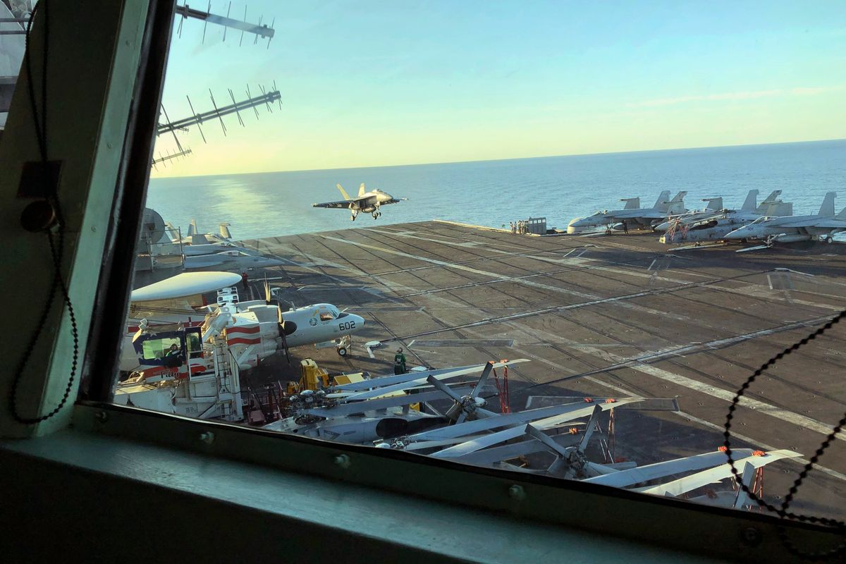 FILE - The view as Marine Gen. Frank McKenzie, top U.S. commander for the Middle East, watches from the bridge as an F/A 18 fighter jet lands on the USS Harry S. Truman, Feb. 1, 2020. Defense Secretary Lloyd Austin has ordered a U.S. Navy aircraft carrier strike group to stay in the Mediterranean Sea region rather than move on to the Middle East, amid worries about the buildup of thousands of Russian troops near the Ukraine border. A defense official said Tuesday, Dec. 28, 2021, that the change in the schedule of the USS Harry S. Truman, and the five American warships accompanying it, reflects the need for a persistent presence in Europe. (Lolita Baldor)