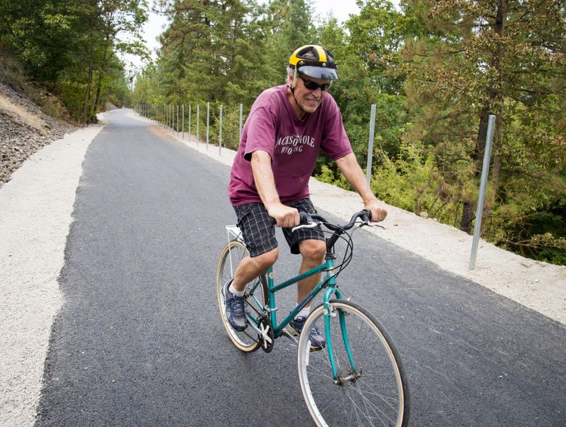 “It’s pretty impressive,” Howard Zickler said as he rides the newly widened and paved Ben Burr Trail between Liberty and Underhill parks Tuesday, Aug 30, 2016. The project has been controversial, and is still getting mixed reviews now that the wider, smooth pathway has nearly been completed. (Colin Mulvany / The Spokesman-Review)