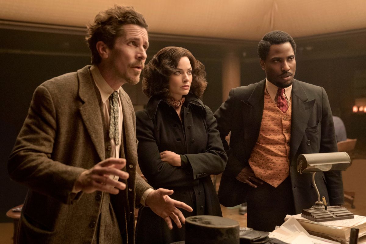 From left, Christian Bale, Margot Robbie and John David Washington in “Amsterdam.” (20th Century Studios)