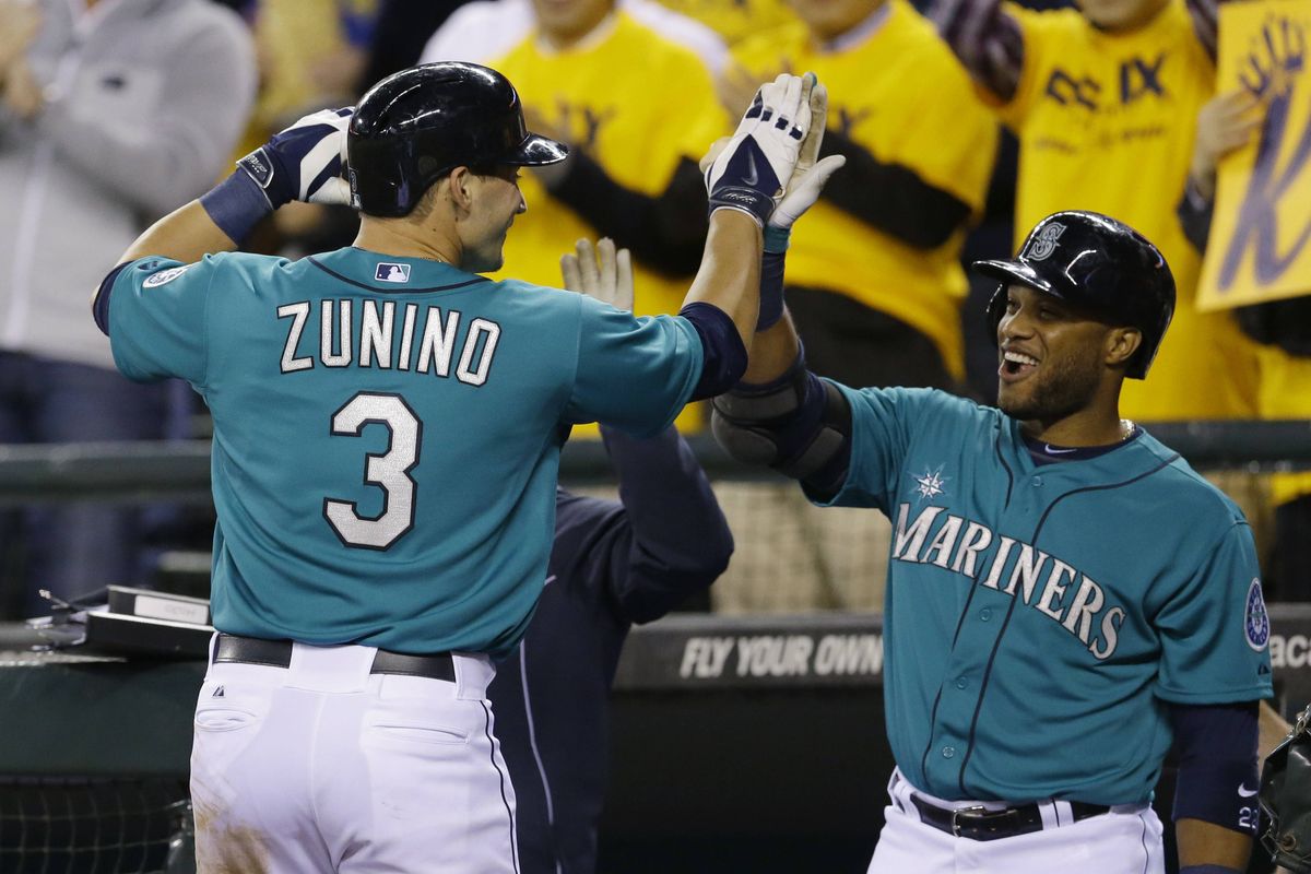 Robinson Cano greets Seattle’s Mike Zunino after his two-run homer in the sixth inning Friday against the A’s. (Associated Press)