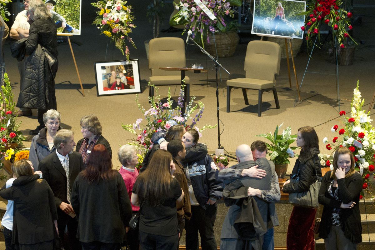 After the funeral service for Tracy Ader and her sons, 10-year-old Damien and 8-year-old Kadin, friends and family console one another Sunday at the Turning Point Open Bible Church. The three were found slain in their north Spokane home Feb. 10. (Colin Mulvany)