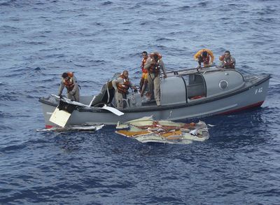 In this photo released by Brazil’s Air Force, officers recover debris from Air France Flight 447  on Sunday.  (Associated Press / The Spokesman-Review)