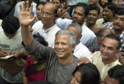 
Bangladeshi Nobel Peace Prize winner Muhammad Yunus waves to well-wishers at his home in Dhaka, Bangladesh, on Friday. 
 (Associated Press / The Spokesman-Review)