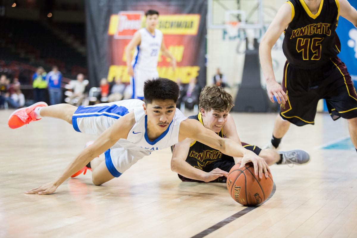 Bryce Strom (1) of Yakama Nation dives for a loose ball against Bode Jansen (20) of Sunnyside during the state 1B championship on Saturday, March 2, 2019 at the Spokane Arena. The Sunnyside Christian Knights beat the Yakama Nation Tribal Eagles 54-45. (Libby Kamrowski / The Spokesman-Review)