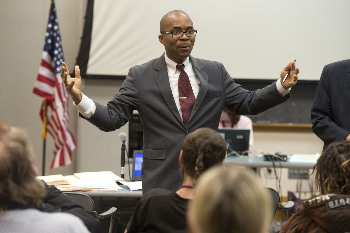 Public defender Francis Adewale greets a crowd of clients and explains the Community Court concept before meeting with them individually on March 3.