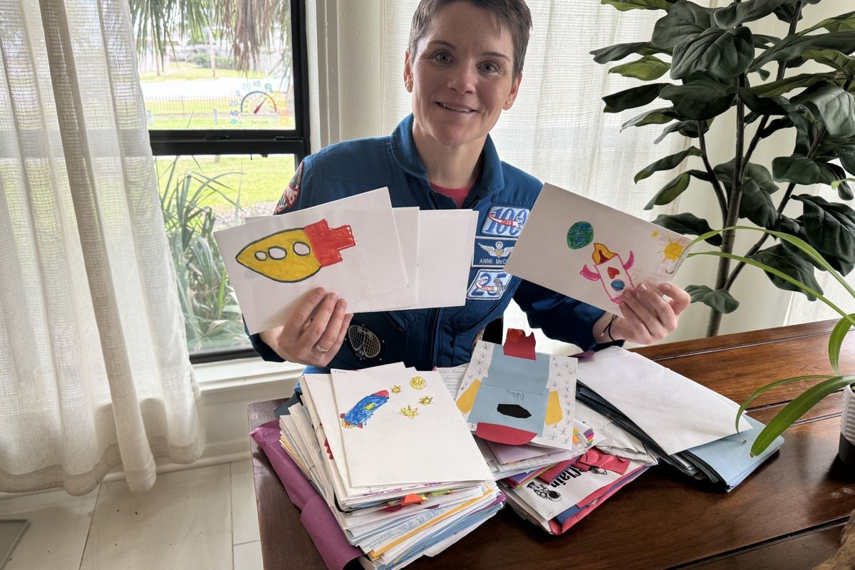 Anne McClain poses with a stack of letters she received from Spokane schoolkids ahead of her launch Wednesday to the International Space Station. (Courtesy Shari Manikowski)