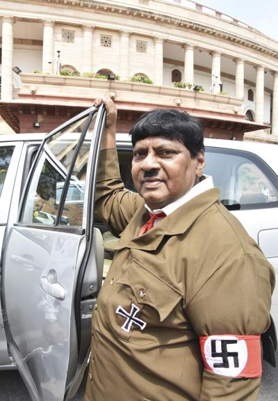 Indian lawmaker Naramalli Sivaprasad stands dressed like Adolf Hitler outside the Indian parliament building in New Delhi, India, Friday, Aug. 10, 2018. Sivaprasa appeared in Parliament dressed like Hitler with a toothbrush moustache and wearing a khaki coat with swastika symbols on his pocket and arm. His demand: More funds for the development of his state in southern India. He said he wanted to send a message to Prime Minister Narendra Modi not to follow Hitler. (Associated Press)