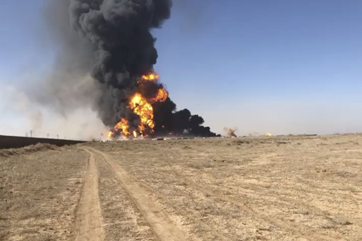 In this still image taken from video, smoke rises from fuel tankers at the Islam Qala border with Iran, in Herat Province, west of Kabul, Afghanistan, Saturday, Feb. 13, 2021. A fuel tanker exploded Saturday at the Islam Qala crossing in Afghanistan