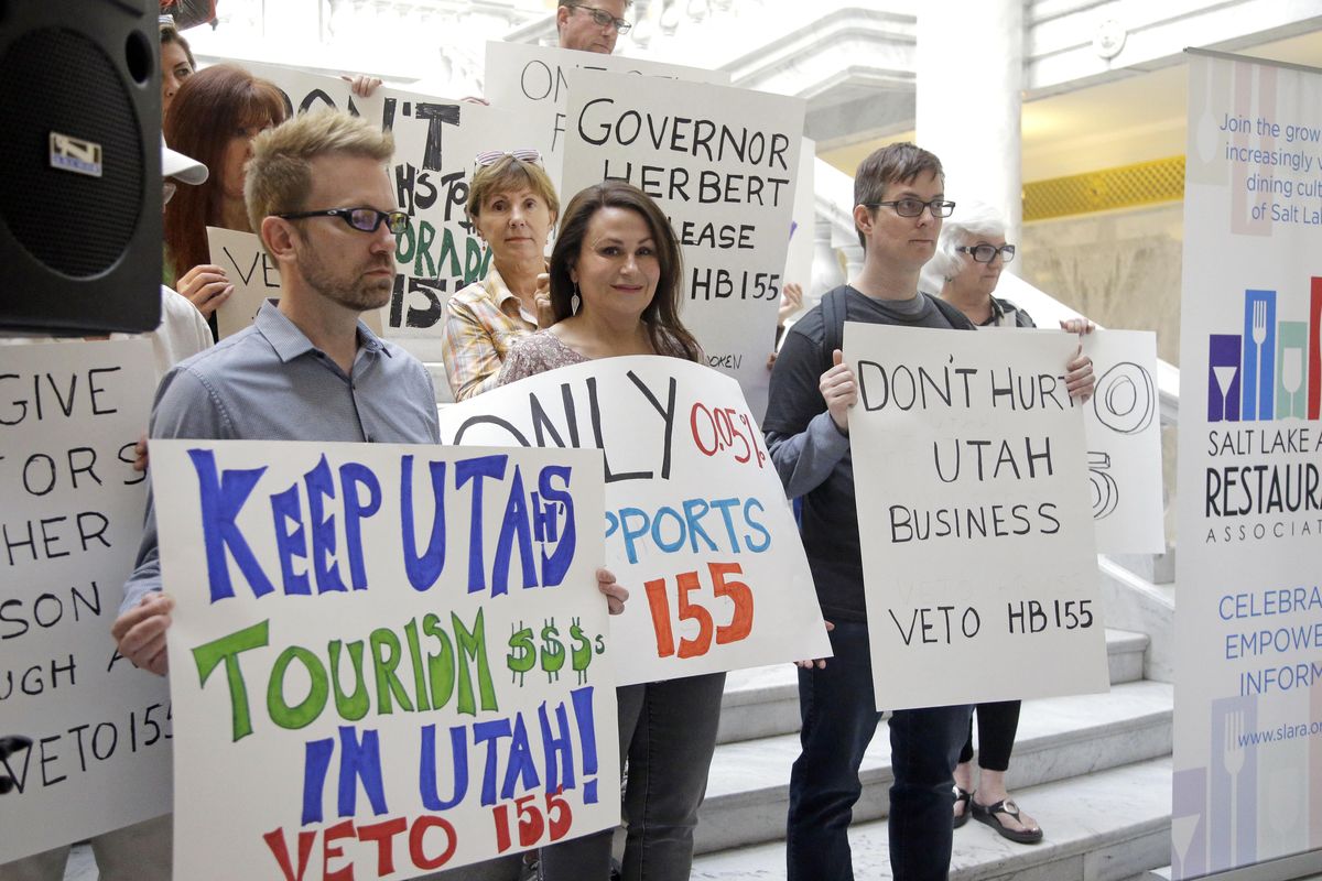 Protesters holds signs during rally concerning the DUI threshold March 17, 2017, at the Utah state Capitol in Salt Lake City. New Year’s Eve revelers in Utah may find themselves with more than a hangover as 2019 dawns: If they drink and drive, they could get hit by the newest and lowest DUI threshold in the nation. The .05 percent limit goes into effect Dec. 30, despite protests that it will punish responsible drinkers, hurt the state’s tourism industry and amplify its alcohol-unfriendly reputation. (Rick Bowmer / AP)