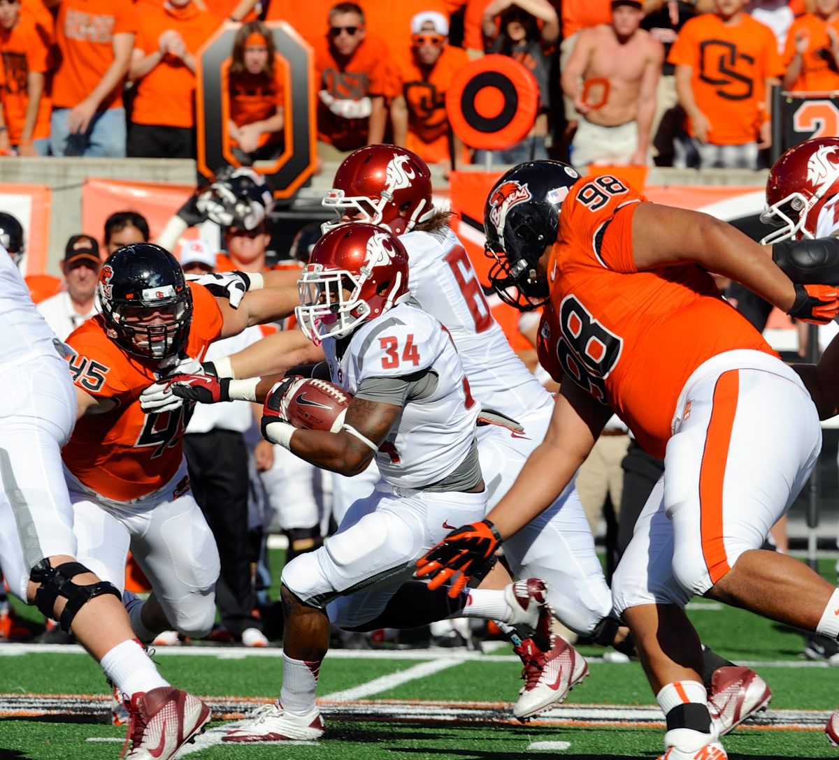 Oregon State's Castro Masaniai (98) and Dylan Wynn (45) defend a run against Washington State's Teondray Caldwell (34) during the first half of an NCAA college football game in Corvallis, Ore., Saturday, Oct. 6, 2012. (Greg Wahl-stephens / Fr29287 Ap)