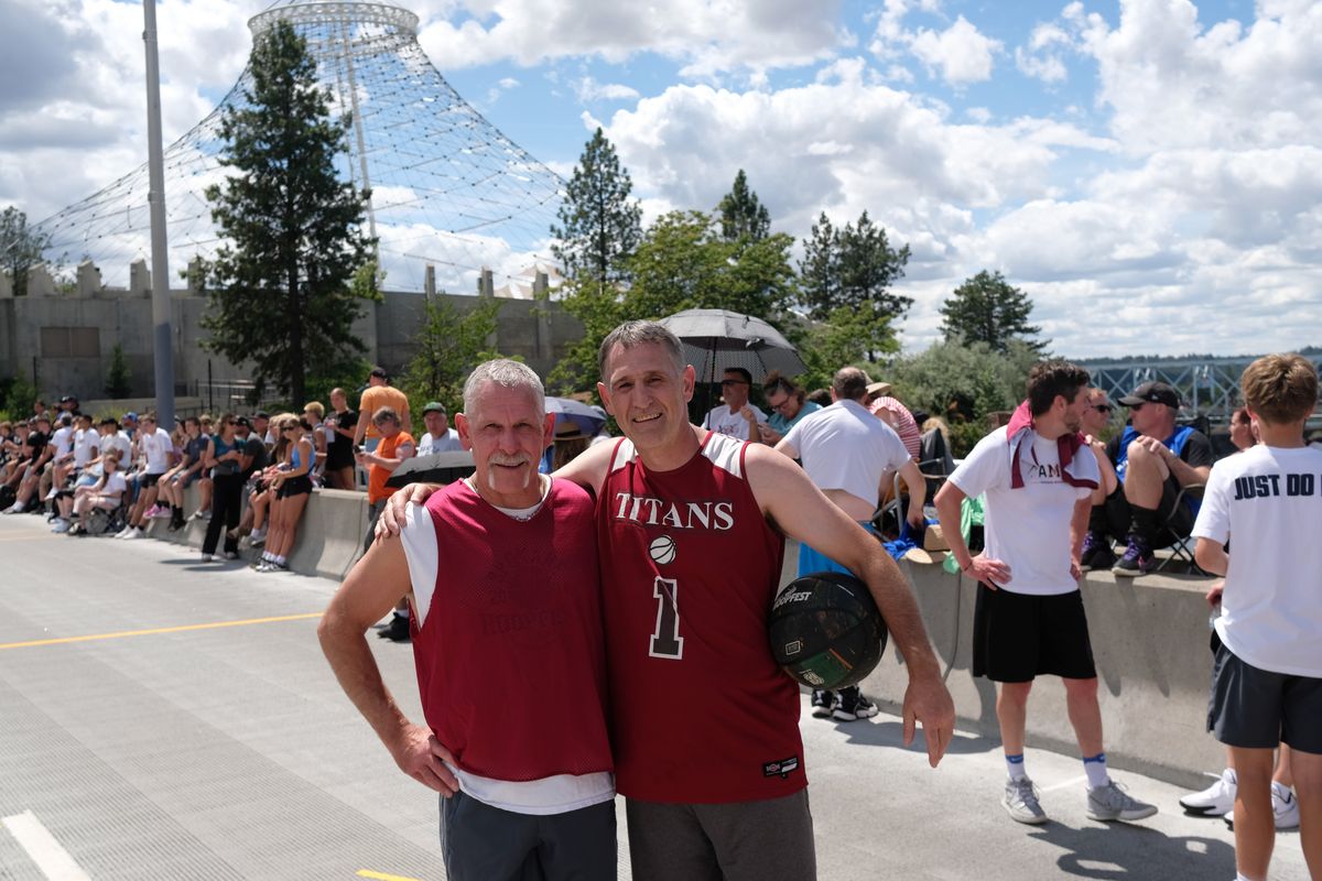 Brothers Garrick and Greg Phillips pose for a photo during Hoopfest on Saturday. The two have competed in every Hoopfest. (Tyler Tjomsland/The Spokesman-Review)