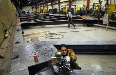
Jeronimo Villalta drills holes into the framework for a new airplane hangar at Garco Building Systems in Airway Heights, Friday. For a client, the facility manufacturs the pieces, assembles them, then breaks them down and ships them to their location. 
 (Rajah Bose / The Spokesman-Review)