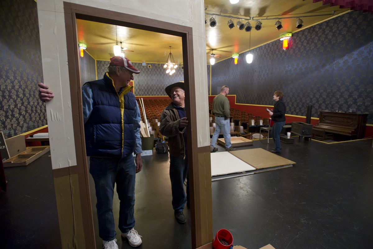 Dick Warwick, left, and Larry Arnold help set up the stage for a production of “Bus Stop” at the historic Empire Theater on Monday. The restored Art Deco building opened in 1940 as a movie theater but is now used as a community performing arts center. (Colin Mulvany)