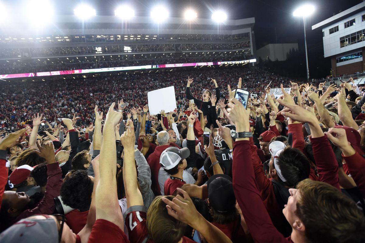 Washington State Cougars fans and players celebrate after WSU defeated USC during the second half of an NCAA college football game on Friday, Sept. 29, 2017 at Martin Stadium in Pullman. (Tyler Tjomsland / The Spokesman-Review)