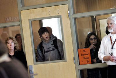 
Anxious students and faculty linger at the school administration office after  a shooting Thursday in Roseburg, Ore.   
 (Associated Press / The Spokesman-Review)