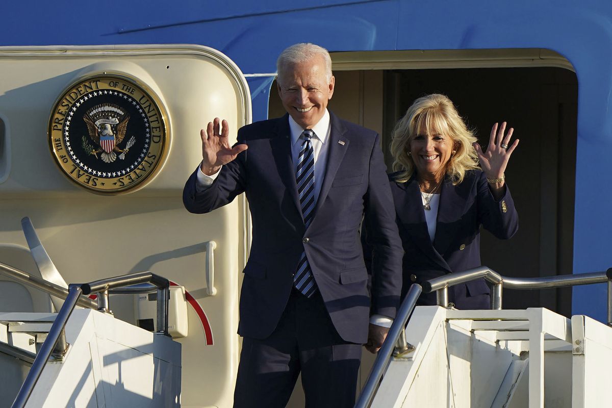 US President Joe Biden and First Lady Jill Biden wave as they arrive Wednesday aboard Air Force One at RAF Mildenhall, England, ahead of the G7 summit in Cornwall.  (Joe Giddens)