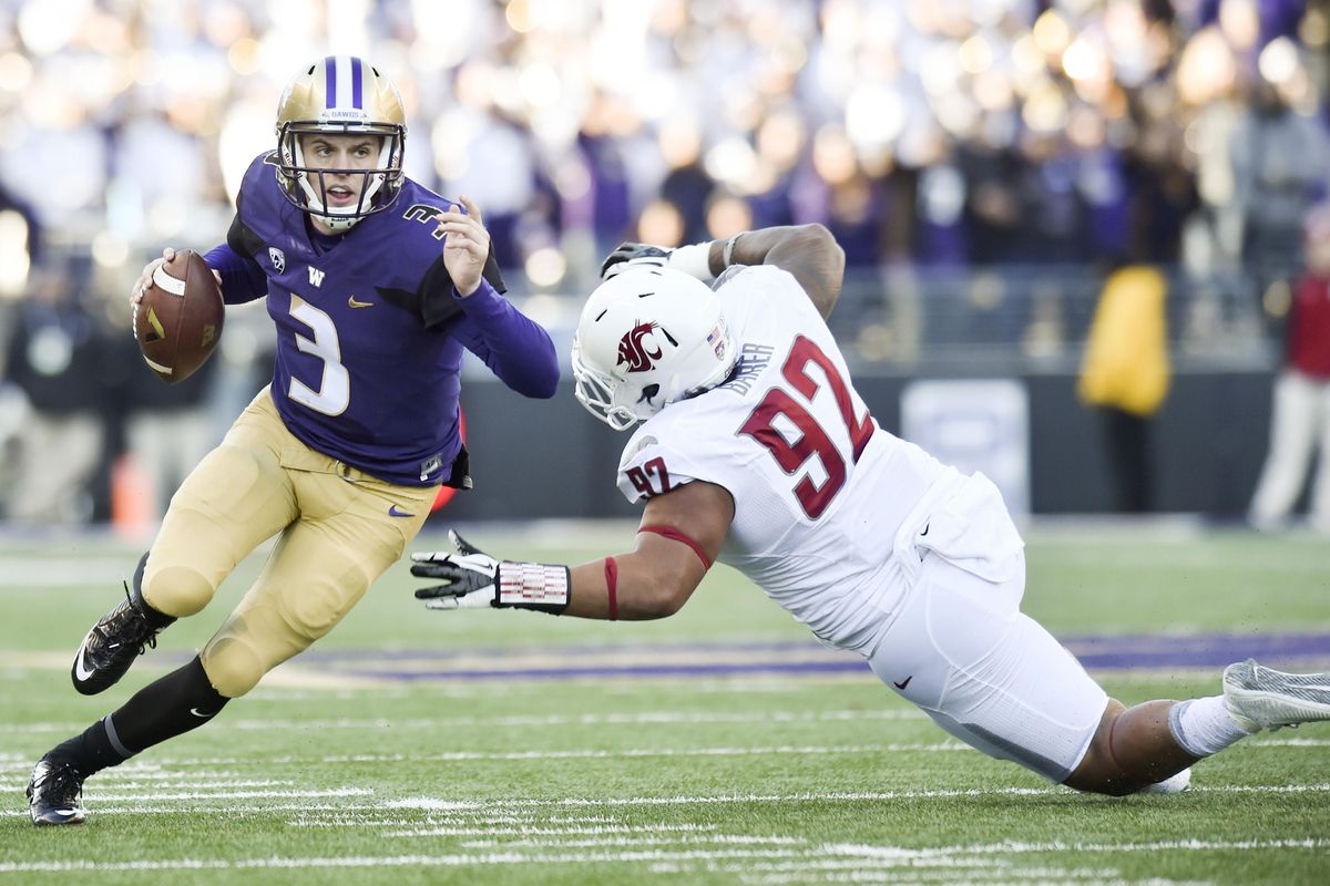 Washington quarterback Jake Browning, left, is being given more to process with the Huskies offense this season. (Tyler Tjomsland / The Spokesman-Review)