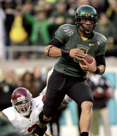 Oregon quarterback Jeremiah Masoli heads to the end zone on a first-half touchdown run.  (Associated Press / The Spokesman-Review)