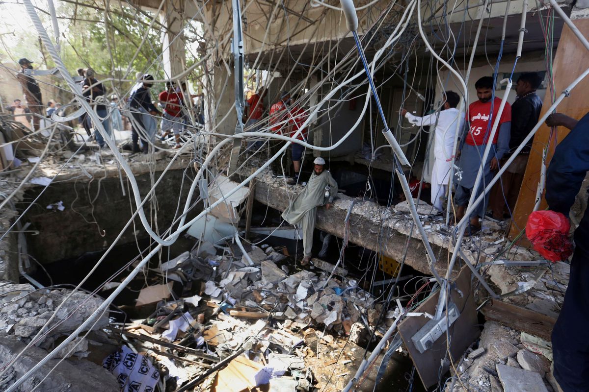 Rescuers inspect the scene of a gas explosion Saturday in Karachi, Pakistan.  (Fareed Khan)