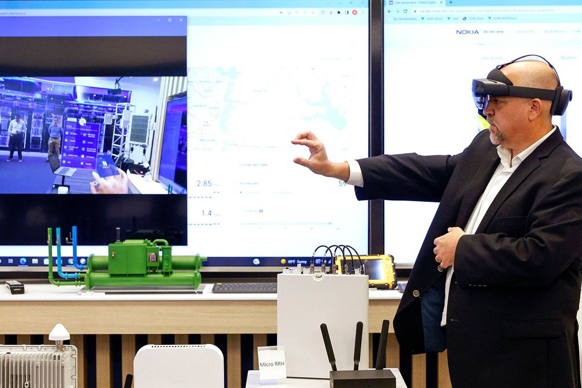 Michael Kelly, demonstration solution architect at Nokia’s executive experience center in Coppell, Texas, demonstrates a real-world use for Microsoft’s HoloLens using Nokia technology.  (Tribune News Service)