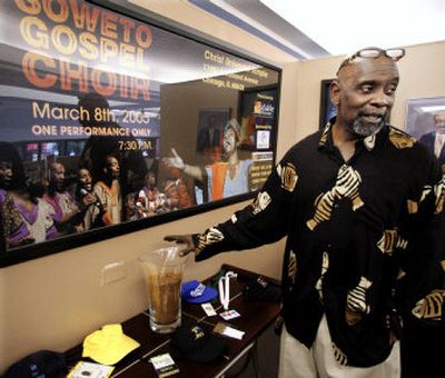 
Chris Gardner, formerly homeless but now chief executive of Gardner Rich & Co., a multimillion-dollar brokerage firm, shows off a vase of dirt from Nelson and Winnie Mandela's back yard in South Africa. 
 (Associated Press / The Spokesman-Review)