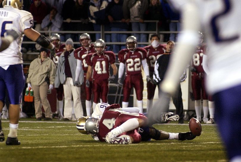 WSU quarterback Matt Kegel watches as the ball bounces away for what was ruled a fumble, giving Washington a triple-overtime Apple Cup win in 2002. (File)