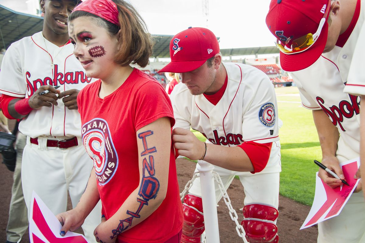 Spokane Indians catcher Guy Edmonds signs the T-shirt of 12-year-old Annalee Oversby during a pregame autograph session on Friday. (Colin Mulvany)