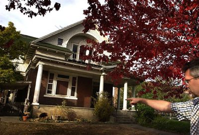
Marshall Clark points to an apartment unit in a suspected drug house at 112 W. Montgomery that sets across from his business and home. The house is owned by Spokane police officer James Jay Olsen. 
 (Jed Conklin / The Spokesman-Review)