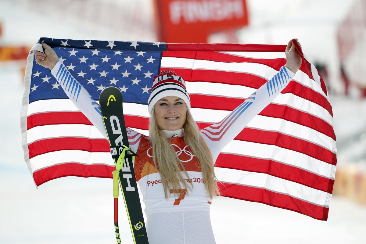 Bronze medal winner Lindsey Vonn, of the United States, celebrates during the flower ceremony for the women