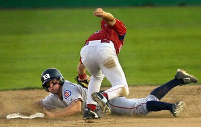 
Matt Matulia holds his breath, but the umpire's verdict will go against him as he's tagged by Indians shortstop Jay Heafner at second base. 
 (Jed Conklin / The Spokesman-Review)