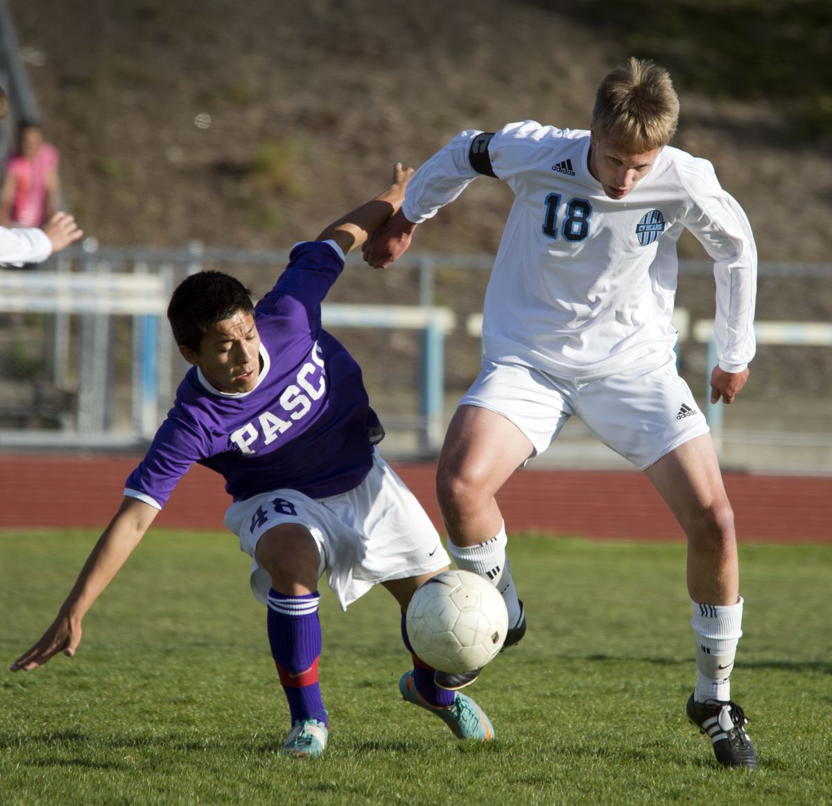 Central Valley’s Karl Ellingson knocks Pasco’s Joel Valle off the ball during the first half of the regional championship May 13 at Central Valley High School. (Dan Pelle)