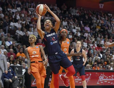 Washington Mystics' Aerial Powers, center, breaks past Connecticut Sun's Courtney Williams, left, and Jonquel Jones, right, for a layup during the second half in Game 3 of basketball's WNBA Finals, Sunday, Oct. 6, 2019, in Uncasville, Conn. (Jessica Hill / Associated Press)