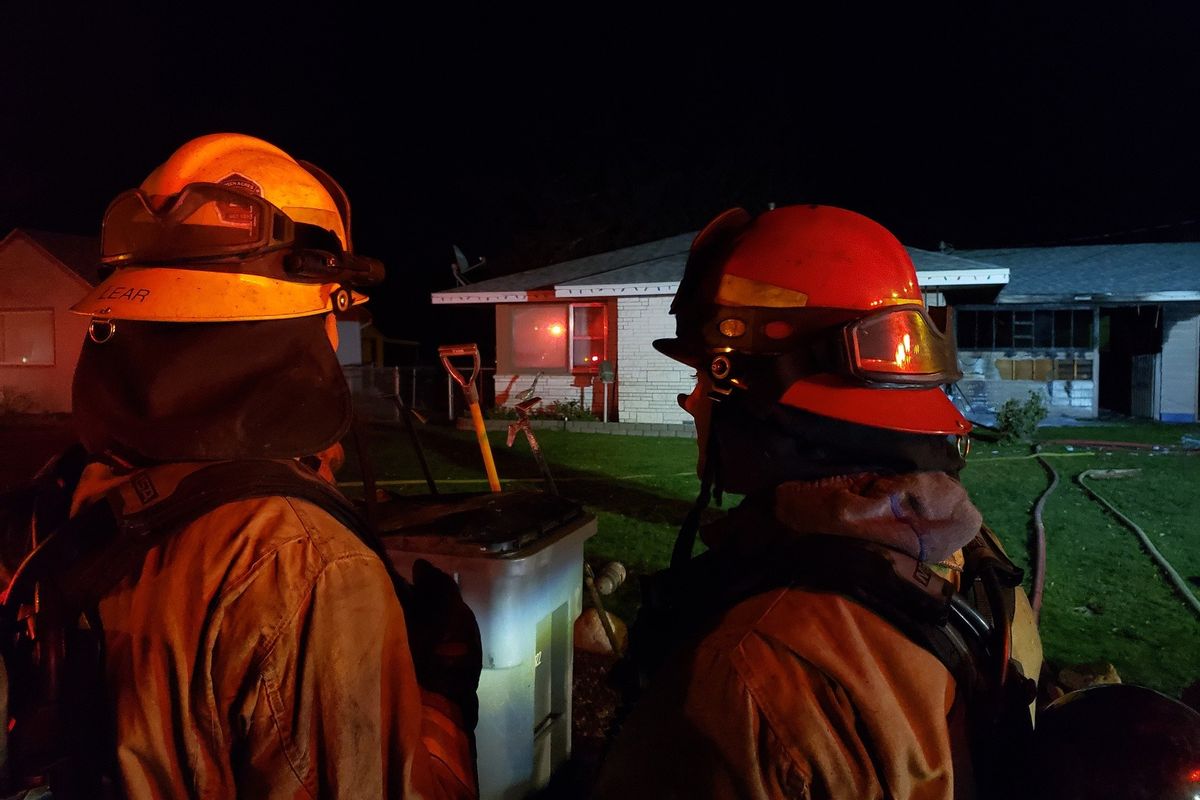 The Spokane Valley Fire Department put out an exterior fire at a house on the 1400 block of South Warren Road in Spokane Valley on Dec. 3, 2021. The damage was mostly in a breezeway connecting the house and garage, background at right.  (Courtesy, SVFD Facebook)