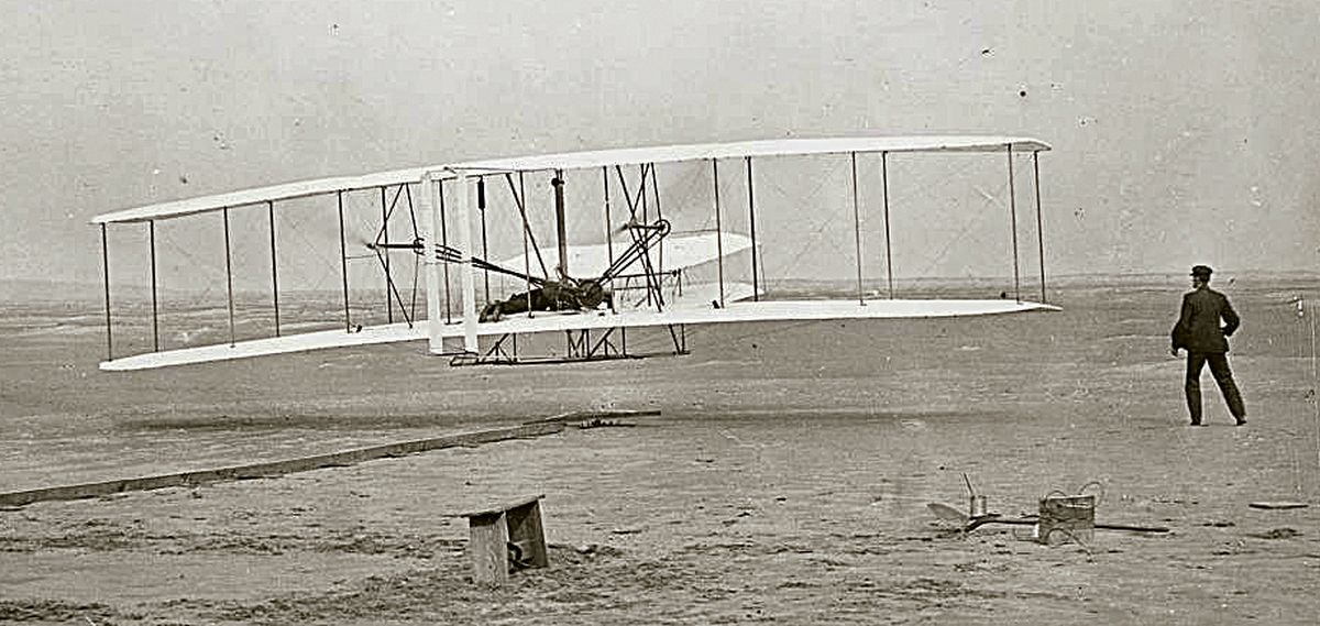 The photo taken by John Thomas Daniels, Jr. captures the first moments of flight at Kitty Hawk, and is commemorated at the Wright Brothers National Memorial. 