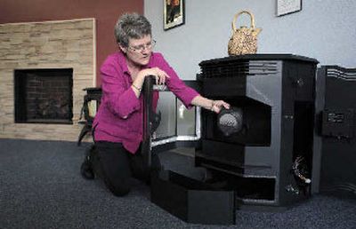 
Cyd Ault holds the burn pot of a wood-pellet stove as she inspects it, the last one in the store, at a business she co-owns with her husband in Albuquerque, N.M. 
 (Associated Press / The Spokesman-Review)