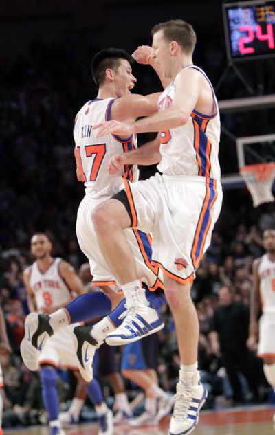 New York’s Jeremy Lin, left, celebrates with Steve Novak after Novak hit a 3-point basket late in the Knicks’ win over Dallas. (Associated Press)