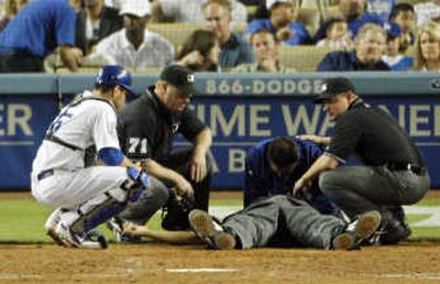 Kerwin Danley, being treated on Saturday, took a 96 mph fastball to the jaw. Associated Press
(Associated Press / The Spokesman-Review)