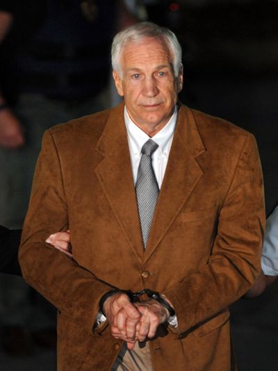Sandusky leaves the Centre County Courthouse Friday in handcuffs after being found guilty in his sexual abuse trial. (Associated Press)