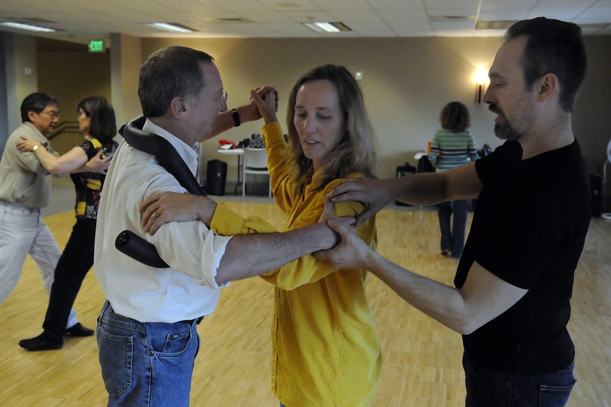 Dance instructor Wade Ramm helps Peter Bunin learn how to hold his arms with his wife, Zoe. The Spokane Valley Parks and Recreation Department is offering a new series of dance classes at CenterPlace as a part of its new spring/summer program.bart@spokesman.com (J. BART RAYNIAK)