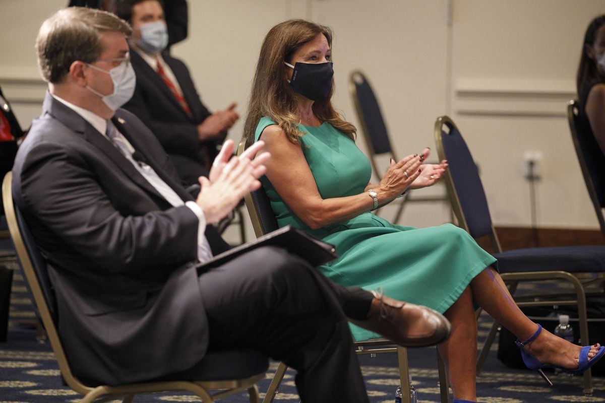 Secretary of Veterans Affairs Richard Wilkie, left, and second lady Karen Pence, wearing protective masks against COVID-19, applaud as they attend an event on a campaign to raise awareness on the risks of veterans suicide, Tuesday, July 7, 2020, at the National Press Club in Washington.  (Jacquelyn Martin)