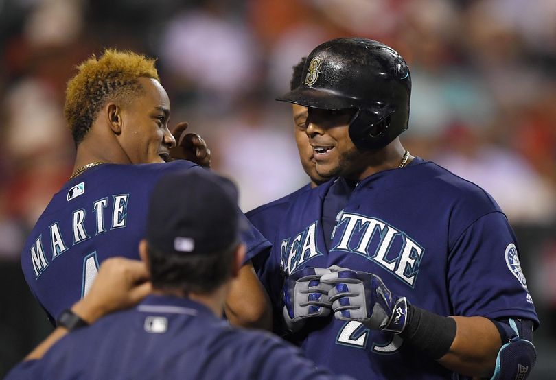 Nelson Cruz, right, brings the power to the Mariners lineup. (Mark J. Terrill / Associated Press)