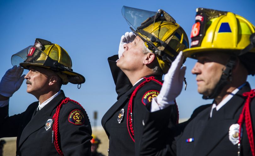 Remembering the fallen, looking toward the future: The Spokane Valley Fire Department continued its tradition Tuesday of honoring the anniversary of the Sept. 11 terrorist attacks by dedicating buildings under construction. Members of the department, Spokane Valley Mayor Tom Towey and others gathered for a ceremony at Station 6 on East Sprague Avenue, which is expected to be complete in mid-November. Construction stopped during the ceremony and several workers gathered at the back of the crowd for the remembrance. The department’s honor guard, including bagpipe players, led the ceremony. Members of the Spokane Valley Fire Department honor guard, including, from left, Greg Bennett, fire inspector, Dave Vegele, engineer/paramedic, and Michael Fields, firefighter, participated in Tuesday morning’s flag raising. (Colin Mulvany)