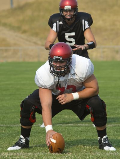 EWU senior center T. J. Boatright, snapping to quarterback Jordan West, will be in Autzen Stadium in Eugene, Oregon on Saturday when Eastern takes on Oregon in the season opener. Boatright's father played for Oregon in the late 80s. (Dan Pelle)