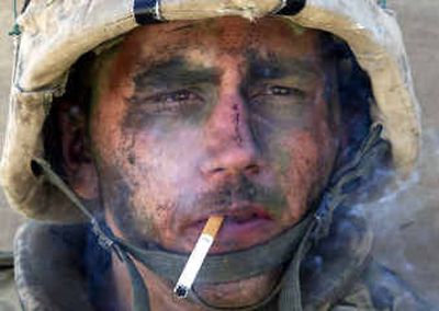 
A member of Charlie Company of the U.S. Marines First Division, Eighth Regiment, smokes in Fallujah on Tuesday as U.S. forces continue their assault on the city. 
 (Associated Press / The Spokesman-Review)