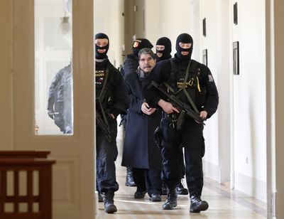 Policemen escort Salih Muslim, former co-chair of the Democratic Union Party, or PYD, to a court room for a custody hearing in Prague, Czech Republic, Tuesday, Feb. 27, 2018. (Petr David Josek / Associated Press)