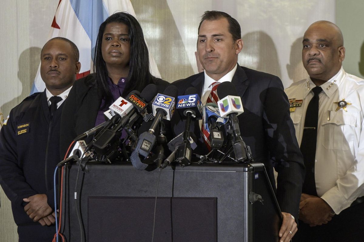 John Lausch, U.S. Attorney for the Northern District of Illinois, at podium, announces federal racketeering charges against five Chicago gang members, Thursday, Oct. 26, 2018 in Chicago. Lausch is joined by, from left to right, Chicago Police 7th District Cmdr. Roderick Robinson, Cook County State’s Attorney Kimm Foxx and Chicago Police Supt. Eddie Johnson. (Nader Issa / AP)