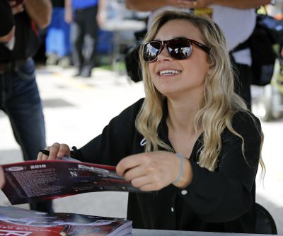 Natalie Decker, pole sitter for the ARCA auto race at Daytona International Speedway, signs autographs, Saturday, Feb. 10, 2018, in Daytona Beach, Fla. (Terry Renna / Associated Press)