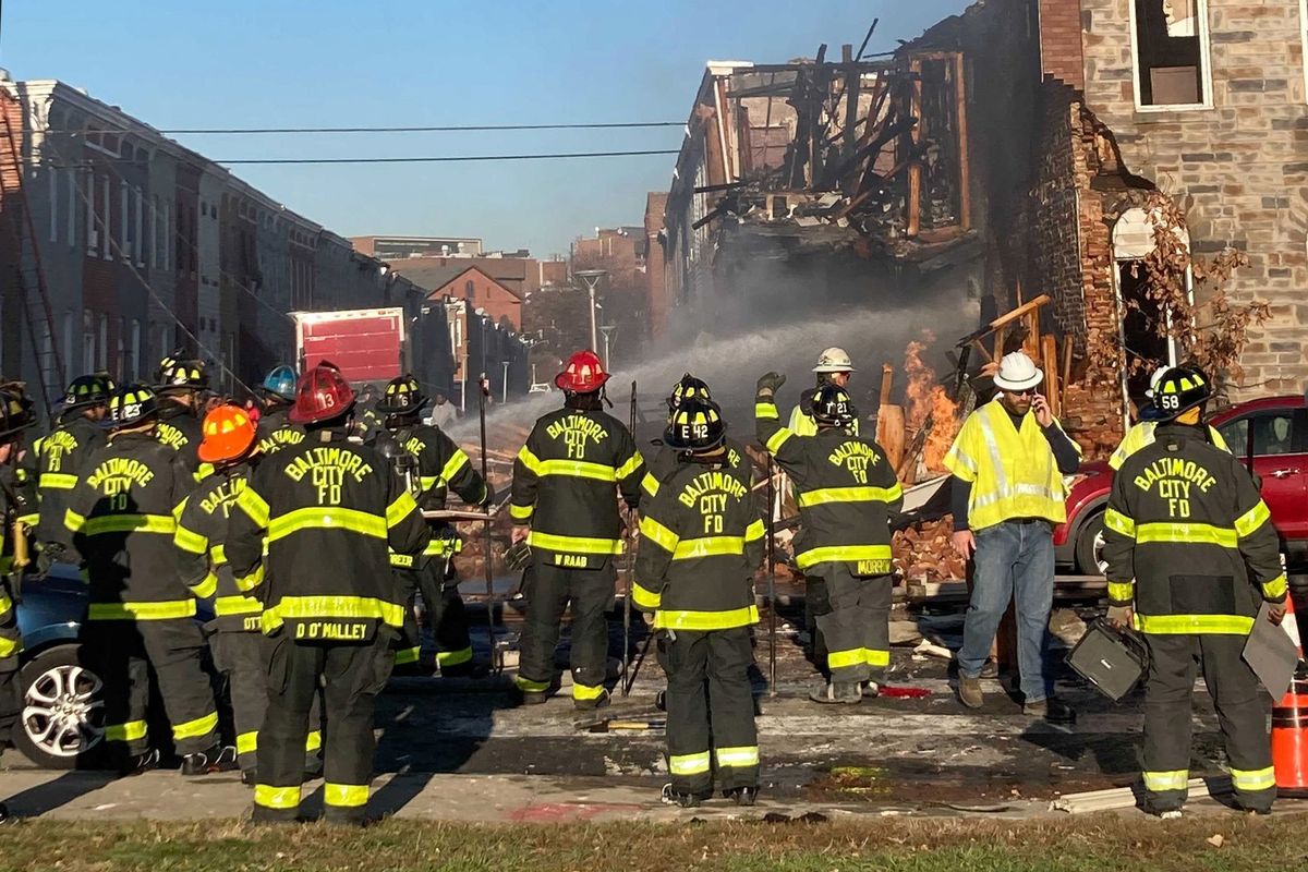 Dozens of Baltimore firefighters gather at the scene of an explosion in Baltimore’s Pigtown neighborhood as water is sprayed on a collapsed home on Tuesday.  (Lilly Price/Baltimore Sun/TNS)
