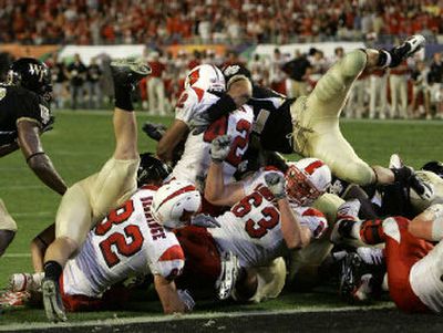 
Louisville's Anthony Allen (42) backs across the goal line to score the go-ahead touchdown in the fourth quarter on Tuesday. 
 (Associated Press / The Spokesman-Review)